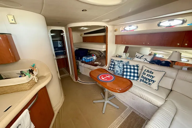 Slide: The Image of Luxurious interior of a 2000 Sea Ray 410 Express Cruiser with cozy seating and nautical decor. - 11