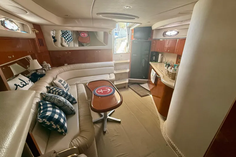 Slide: The Image of Luxurious interior of a 2000 Sea Ray 410 Express Cruiser with elegant seating and kitchenette. - 12