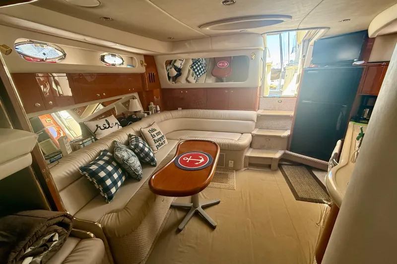 Slide: The Image of Luxurious interior of a 2000 Sea Ray 410 Express Cruiser with elegant seating and decor. - 13