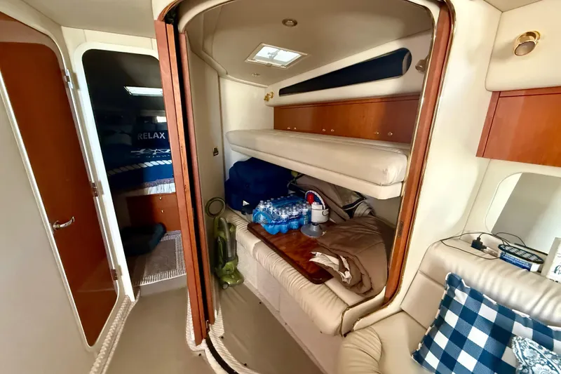 Slide: The Image of Interior of 2000 Sea Ray 410 Express Cruiser with cozy seating and storage. - 15