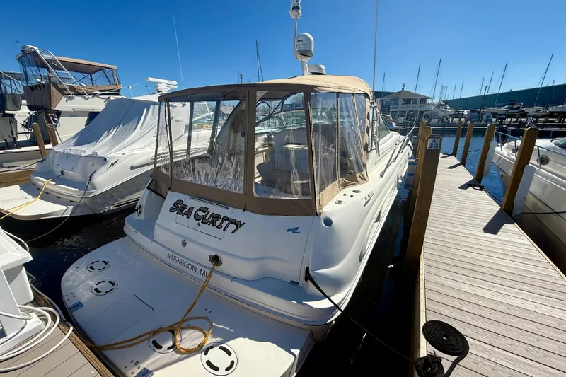 Slide: The Image of 2000 Sea Ray 410 Express Cruiser docked at marina under clear blue sky. - 2