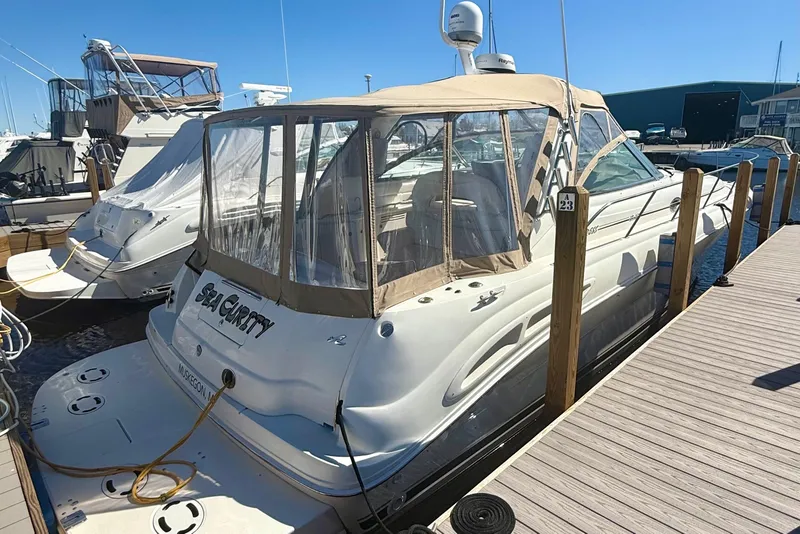 Slide: The Image of 2000 Sea Ray 410 Express Cruiser docked at marina under clear blue sky. - 3