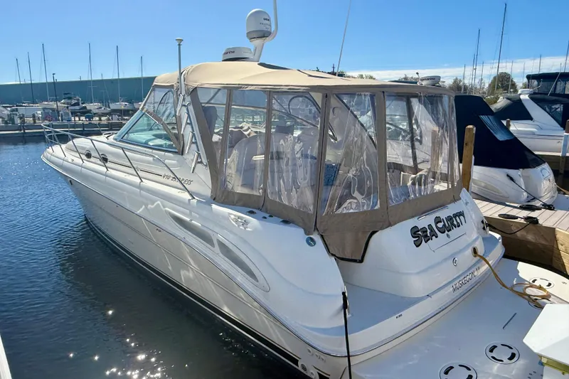 Slide: The Image of 2000 Sea Ray 410 Express Cruiser docked at marina under clear skies. - 4
