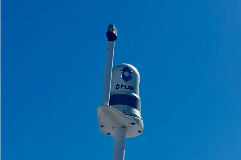 Slide: The Image of FLIR camera mounted on a 2000 Sea Ray 410 Express Cruiser against clear blue sky. - 9