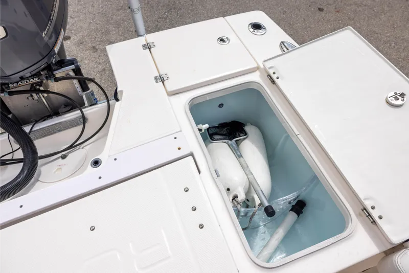 Slide: The Image of Storage compartment on a 2015 Robalo 246 Cayman boat, containing marine equipment. - 11