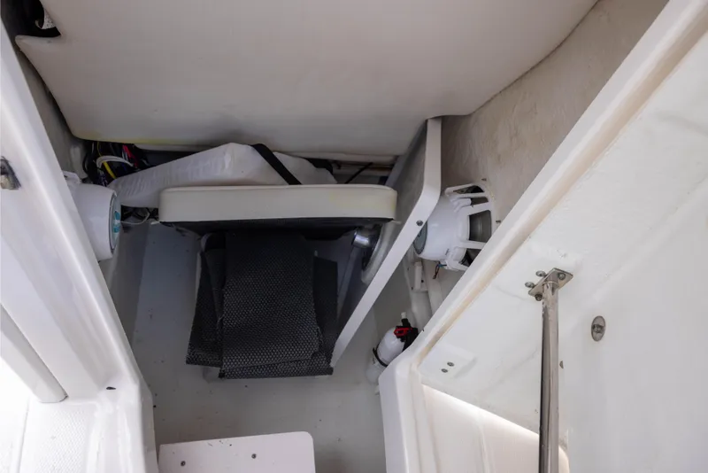 Slide: The Image of Interior view of a 2015 Robalo 246 Cayman boat storage compartment. - 16