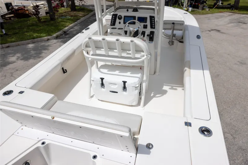 Slide: The Image of 2015 Robalo 246 Cayman boat interior with helm, seating, and storage compartments. - 7