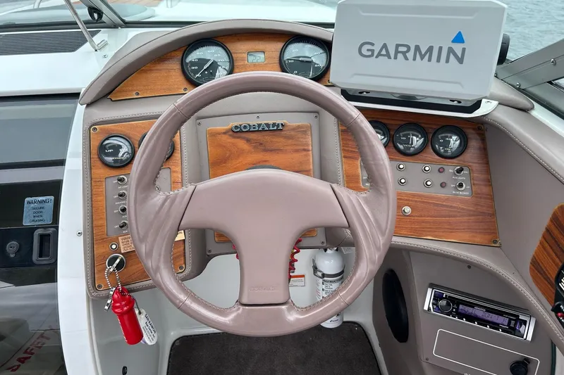 Slide: The Image of Steering wheel and dashboard of a 1995 Cobalt 253 boat with Garmin navigation. - 10
