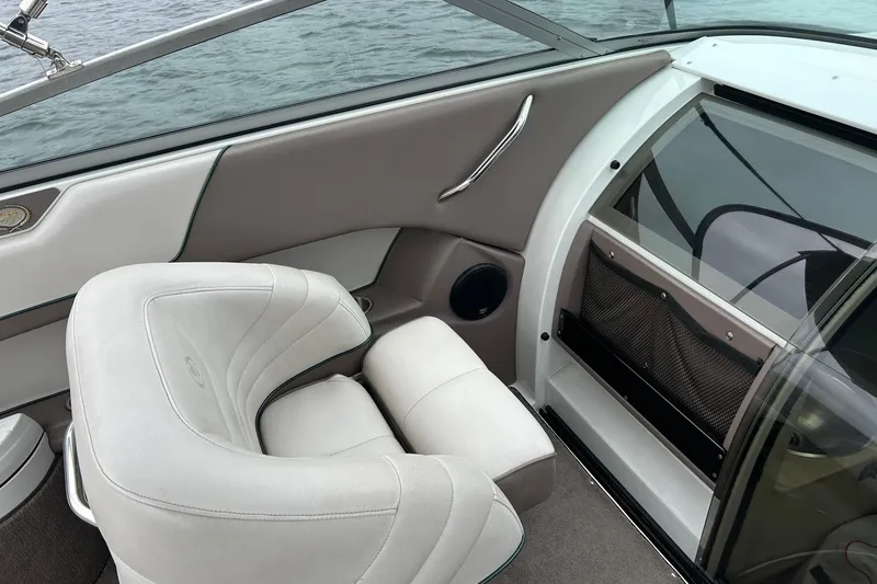 Slide: The Image of Interior of a 1995 Cobalt 253 boat with white seating and sleek design. - 12