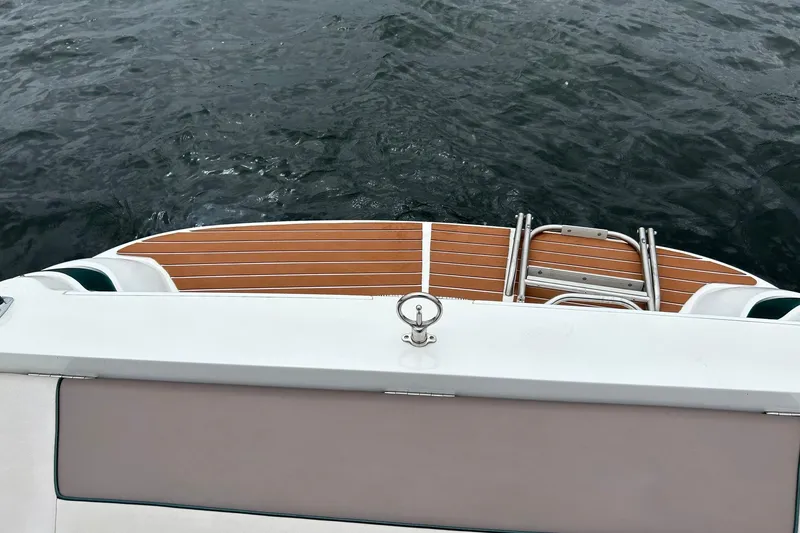 Slide: The Image of Rear view of a 1995 Cobalt 253 boat with wooden deck and ladder. - 15