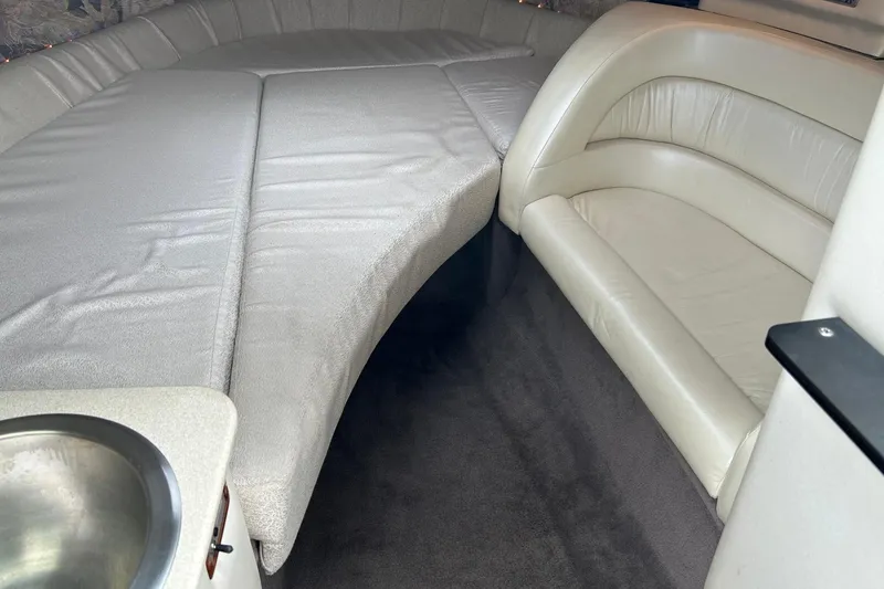 Slide: The Image of Interior of a 1995 Cobalt 253 boat with plush seating and a small sink. - 5