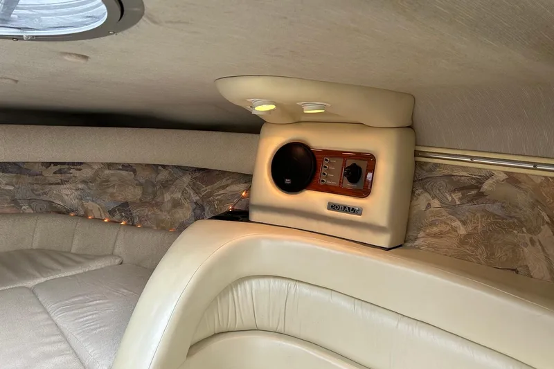Slide: The Image of Interior of a 1995 Cobalt 253 boat with beige upholstery and speaker system. - 6