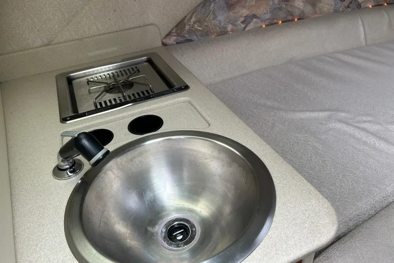 Slide: The Image of Compact kitchenette in a 1995 Cobalt 253 boat with sink and stove. - 7