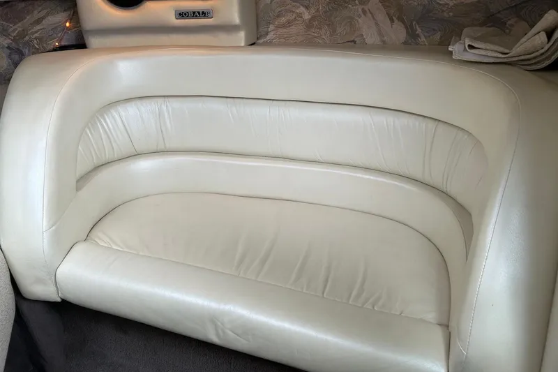 Slide: The Image of Cream leather seating in a 1995 Cobalt 253 boat interior. - 8