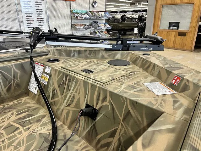 Slide: The Image of Lowe Skorpion SS 2026 boat with camouflage design in showroom. - 6