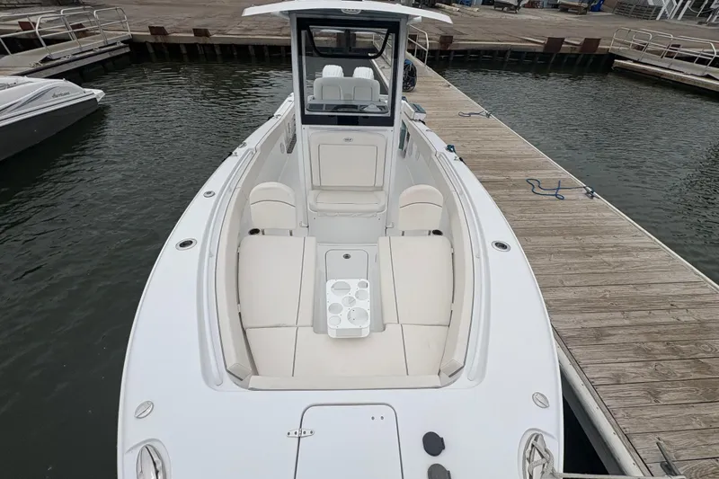 Slide: The Image of 2025 Sea Hunt Gamefish 25 boat docked, featuring spacious seating and modern design. - 13