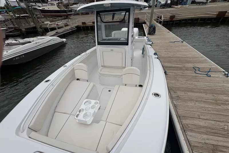 Slide: The Image of 2025 Sea Hunt Gamefish 25 boat docked, featuring spacious seating and modern design. - 15