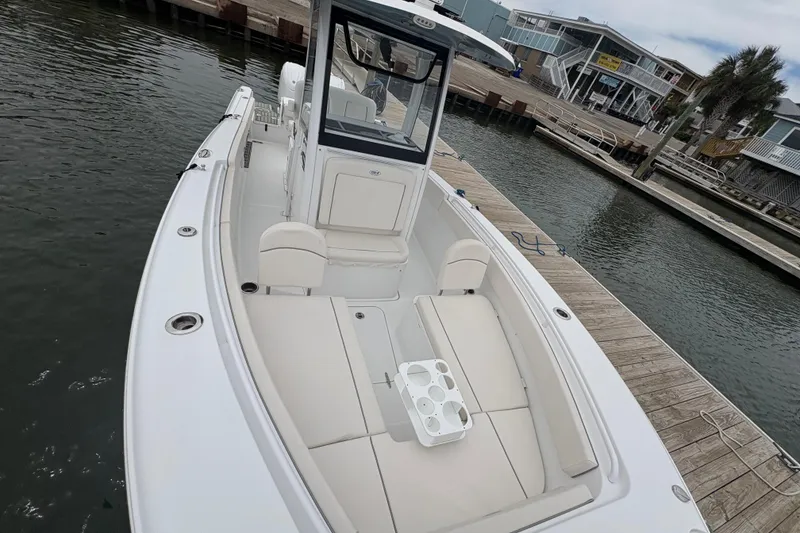 Slide: The Image of 2025 Sea Hunt Gamefish 25 boat docked, featuring spacious seating and modern design. - 16