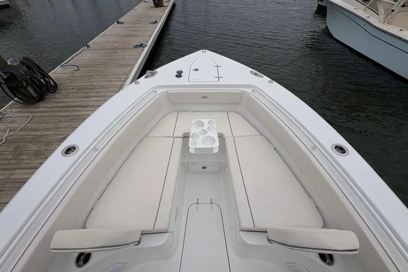 Slide: The Image of 2025 Sea Hunt Gamefish 25 boat with spacious seating and cup holders at dock. - 17