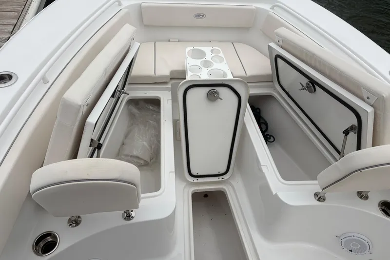 Slide: The Image of 2025 Sea Hunt Gamefish 25 boat interior with open storage compartments and seating. - 18