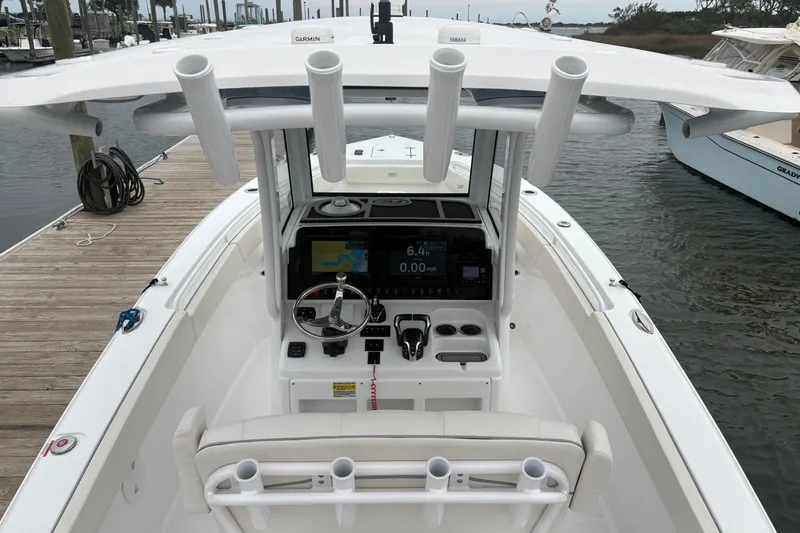Slide: The Image of 2025 Sea Hunt Gamefish 25 boat interior with advanced navigation system at dock. - 23