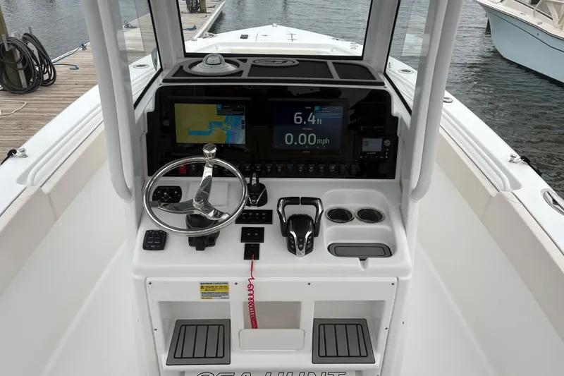 Slide: The Image of 2025 Sea Hunt Gamefish 25 boat dashboard with navigation and control systems. - 24