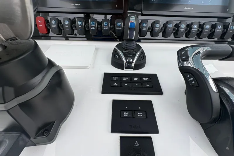 Slide: The Image of Control panel of 2025 Sea Hunt Gamefish 25 boat with Garmin displays and Yamaha controls. - 30