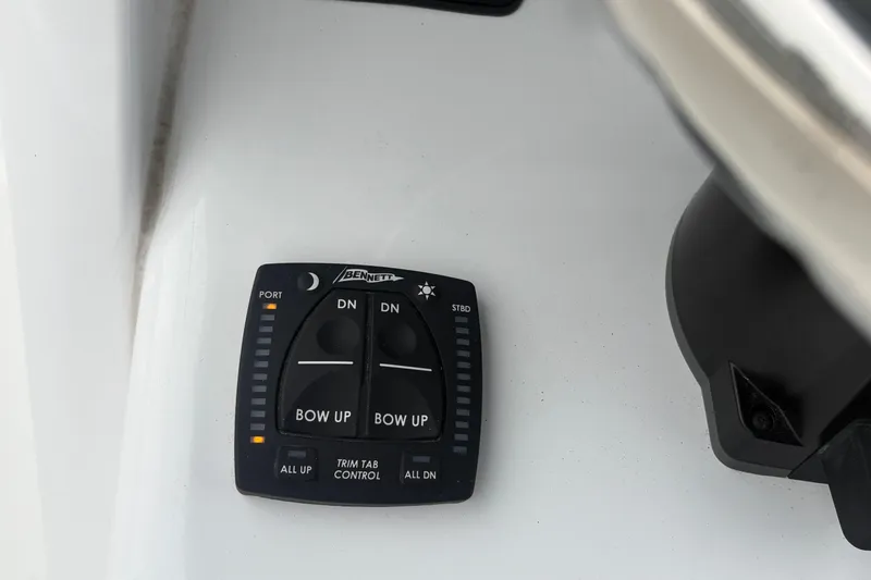 Slide: The Image of Trim tab control panel on 2025 Sea Hunt Gamefish 25 boat dashboard. - 33