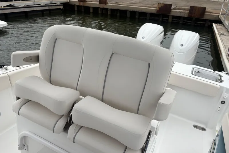 Slide: The Image of 2025 Sea Hunt Gamefish 25 boat with dual cushioned seats and twin outboard motors. - 34