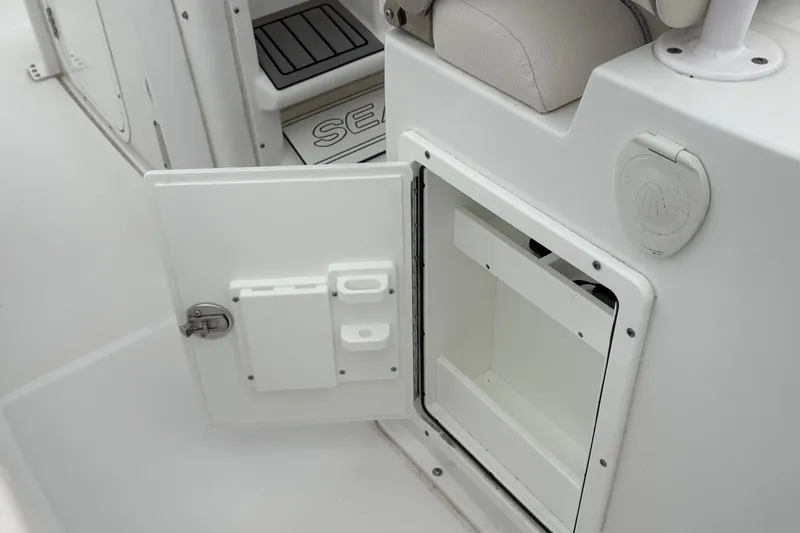 Slide: The Image of 2025 Sea Hunt Gamefish 25 boat storage compartment with open door. - 39