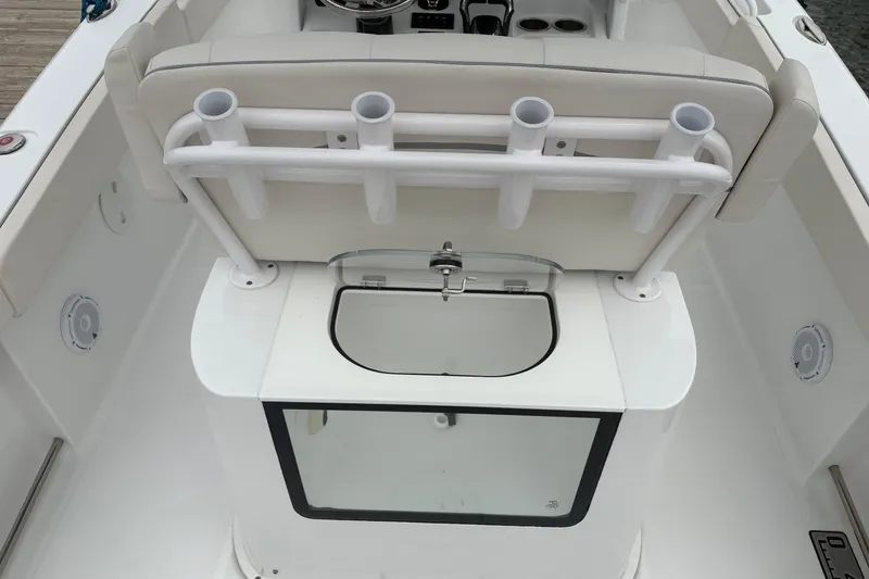 Slide: The Image of 2025 Sea Hunt Gamefish 25 boat interior with rod holders and livewell. - 40