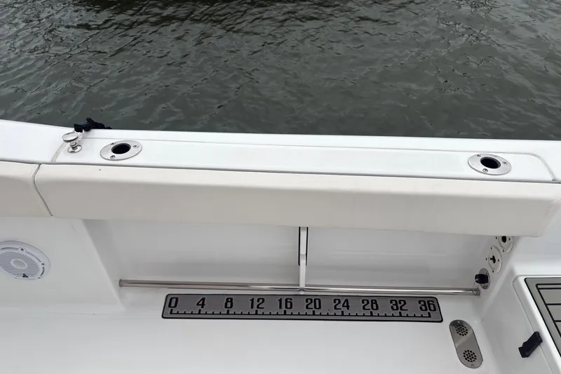 Slide: The Image of 2025 Sea Hunt Gamefish 25 boat interior with rod holders and measurement scale. - 42