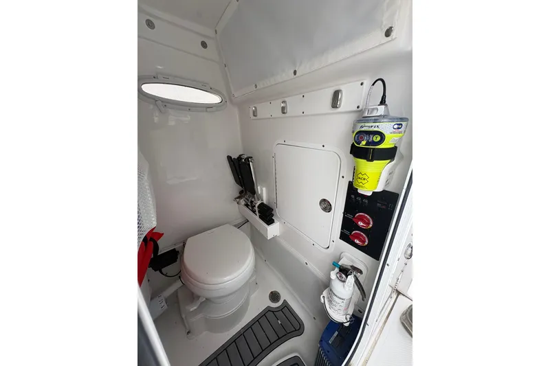 Slide: The Image of Interior of 2025 Sea Hunt Gamefish 25 boat, featuring a compact marine toilet. - 48
