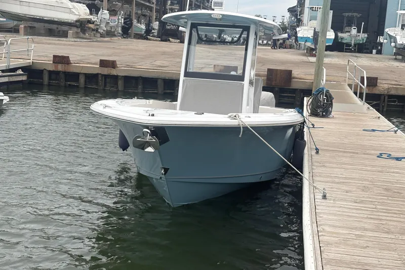 Slide: The Image of 2025 Sea Hunt Gamefish 25 boat docked at marina, showcasing sleek design and modern features. - 6