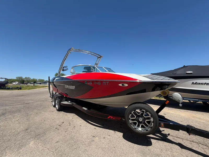 Slide: The Image of 2015 MB SPORTS B52 23 boat on trailer under clear blue sky. - 1