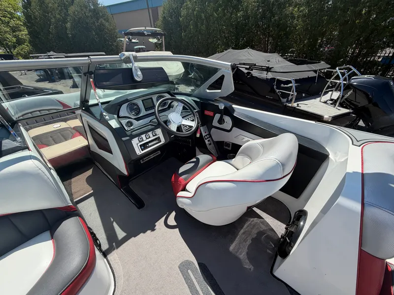 Slide: The Image of Interior of a 2015 MB SPORTS B52 23 boat with steering console. - 13