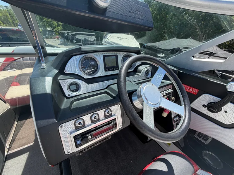 Slide: The Image of Interior of a 2015 MB SPORTS B52 23 boat with steering console. - 14