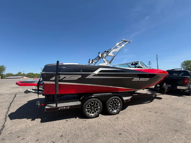 Slide: The Image of 2015 MB SPORTS B52 23 boat on trailer under sunny skies. - 2