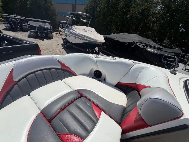Slide: The Image of Interior of a 2015 MB SPORTS B52 23 boat with red and gray seating. - 25