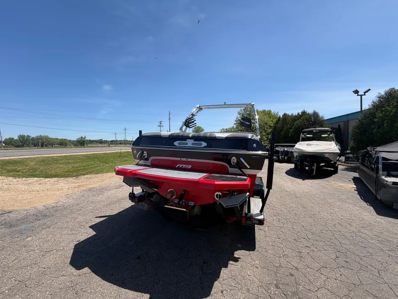 Slide: The Image of Rear view of a 2015 MB SPORTS B52 23 boat in a parking lot. - 3