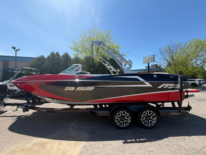 Slide: The Image of 2015 MB SPORTS B52 23 boat on trailer under sunny sky. - 5