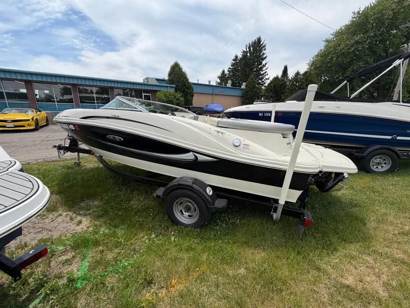 Slide: The Image of 2010 Sea Ray 185 SP/SS boat on trailer outdoors. - 13