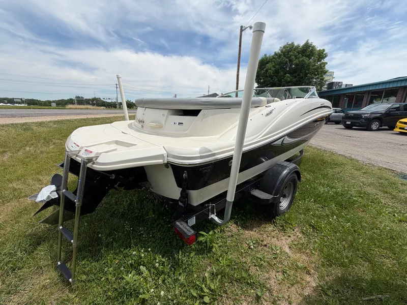 Slide: The Image of 2010 Sea Ray 185 SP/SS boat on trailer, grassy area. - 15