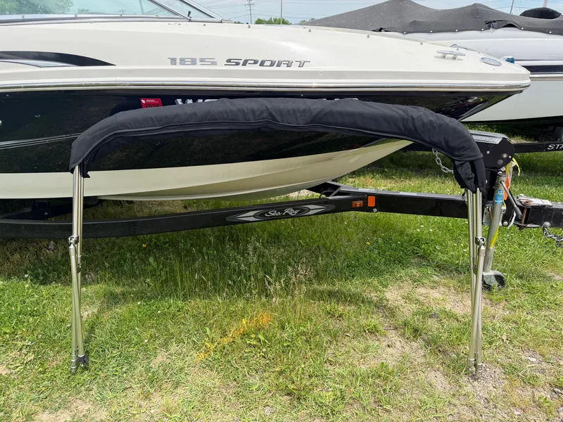 Slide: The Image of 2010 Sea Ray 185 SP/SS boat parked on trailer outdoors. - 16