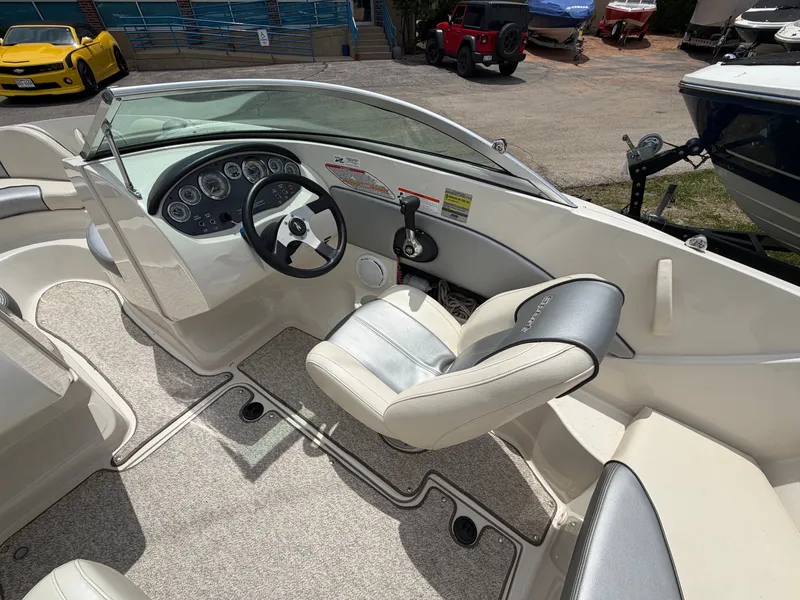 Slide: The Image of Interior of a 2010 Sea Ray 185 SP/SS boat with steering console. - 21