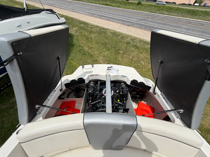 Slide: The Image of 2010 Sea Ray 185 SP/SS engine compartment with open covers. - 33
