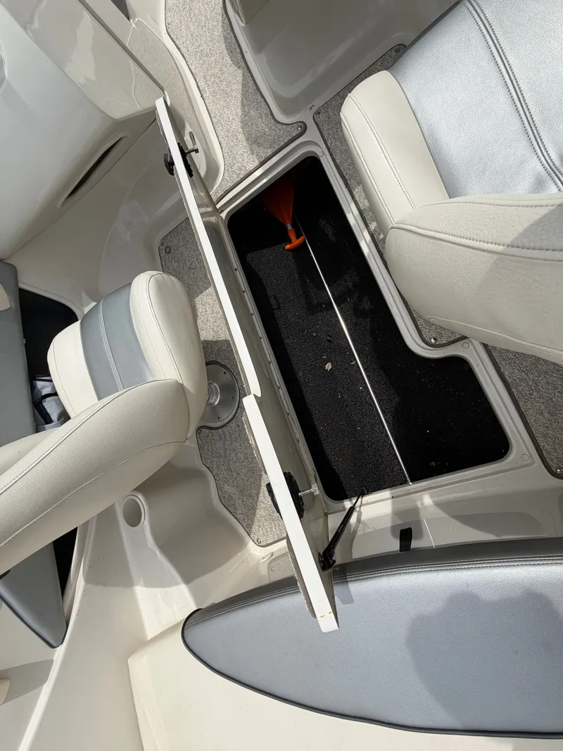 Slide: The Image of Interior of a 2010 Sea Ray 185 SP/SS boat with open storage compartment. - 36