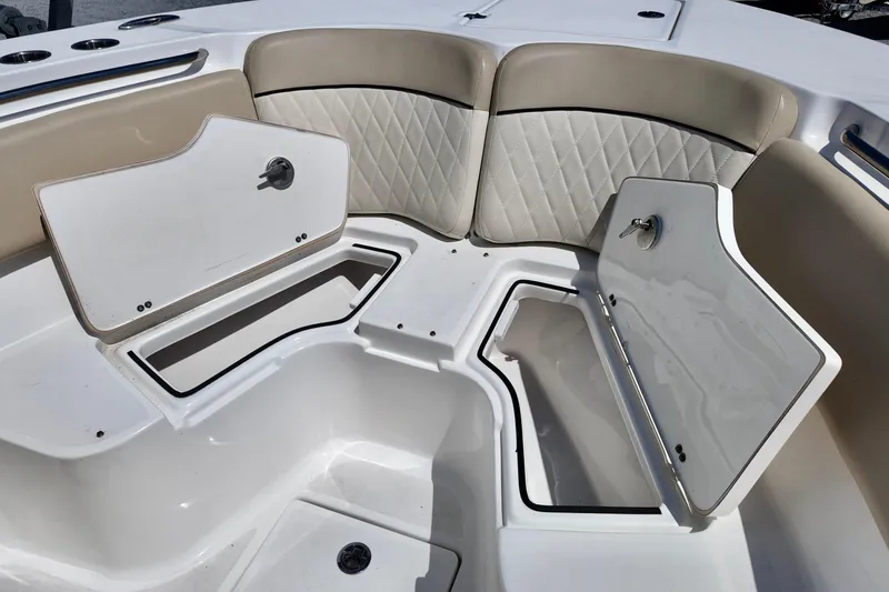Slide: The Image of 2017 Sea Fox 288 Commander boat with open storage compartments and cushioned seating. - 18