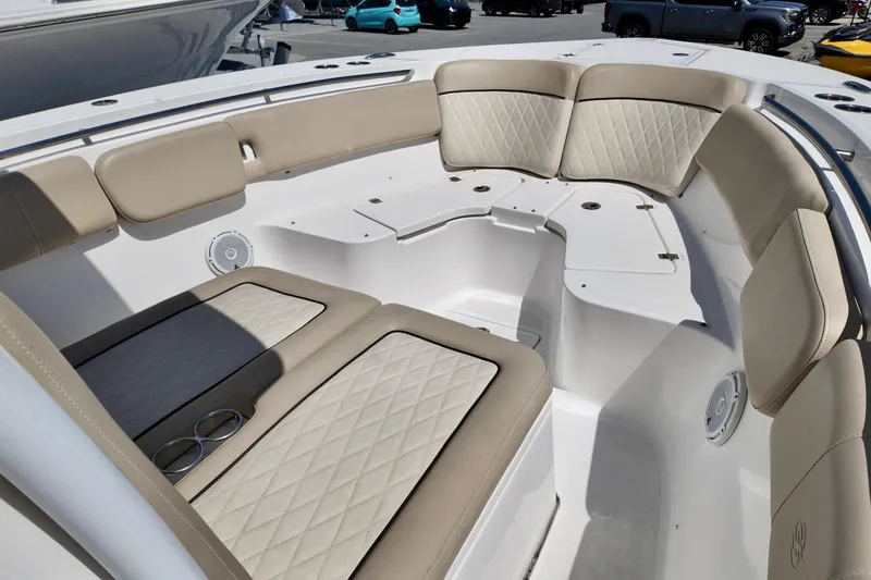 Slide: The Image of 2017 Sea Fox 288 Commander boat interior with beige cushioned seating and cup holders. - 19
