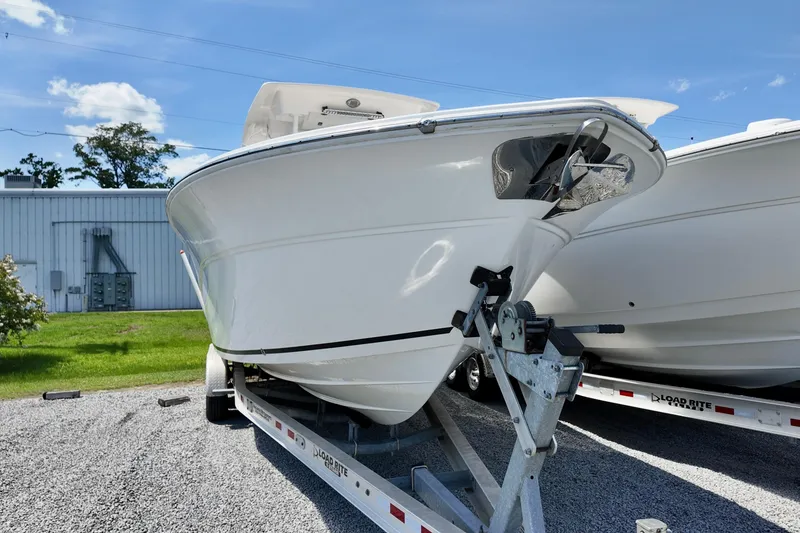Slide: The Image of 2017 Sea Fox 288 Commander boat on trailer, parked outdoors under blue sky. - 2